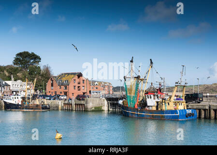Spring sunshine and blue skies with two Beam Trawlers moored in Padstow harbour on the North Cornwall coast. Stock Photo