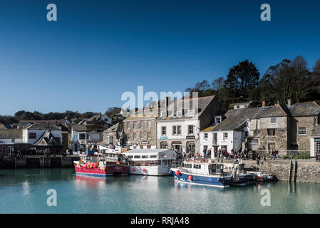 Spring sunshine and blue skies over yachts and fishing boats moored in Padstow harbour on the North Cornwall coast. Stock Photo