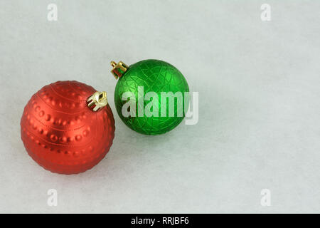 Red and green Christmas ornaments on white background Stock Photo