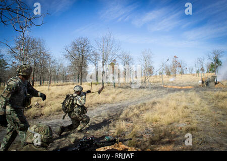 A paratrooper from Company C, 2nd Battalion, 505th Parachute Infantry Regiment, 3rd Brigade Combat Team, 82nd Airborne Division throws a grappling hook towards an obstacle to begin a breach during the Company's live-fire exercise conducted Sunday, February 24 on Fort Bragg, North Carolina. Stock Photo