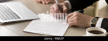 Closeup hands businessman sitting at desk accomplish meeting signing contract  Stock Photo