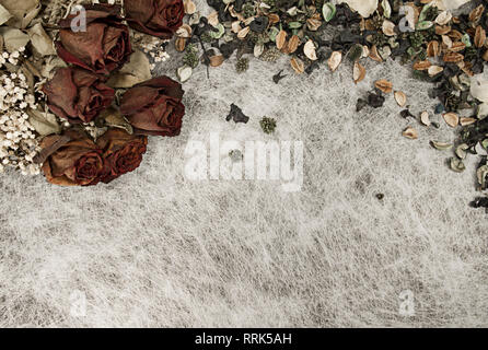 Romantic background in soft autumn colors with dried roses and pot pourri on white rice paper Stock Photo