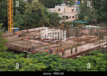 Construction workers laying slab at a construction site. Stock Photo