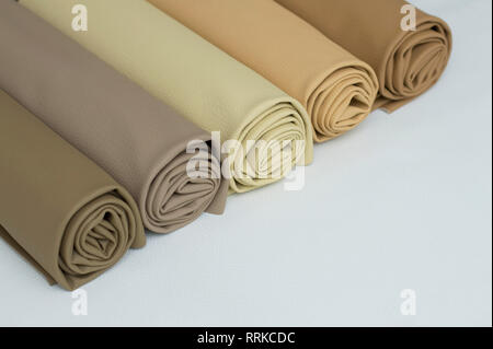 Leather rolls of brown color shades on white background. Stock Photo