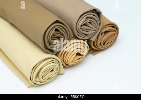 Leather rolls stack of brown color shades on white background. Stock Photo