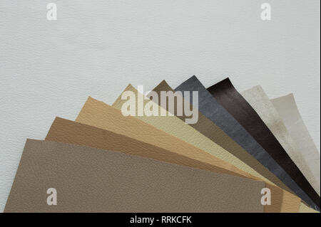 Leather sheet stack of gray and brown color shades on white background. Stock Photo