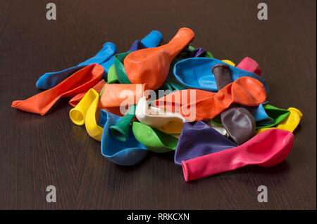 Colorful empty balloons over wooden table. Stock Photo