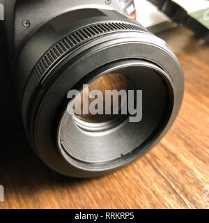 Camera lens close up on a wooden surface Stock Photo