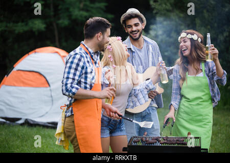 Group of friends making barbecue in the nature Stock Photo