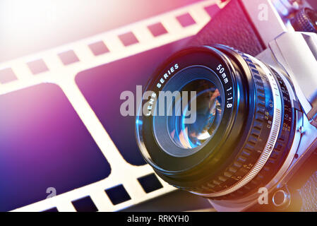 Lens SLR camera on the background of the perforation of film Stock Photo