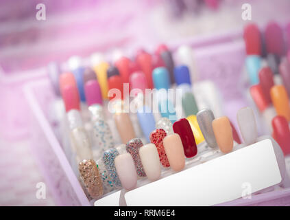 Colorful artificial Nails in nail salon shop. Set of false nails for customer to choose color for manicure or pedicure in nail salon and spa shop. Nai Stock Photo