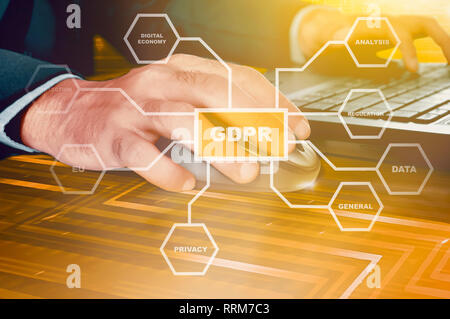 Businessman working with mouse and laptop on the futuristic desk with GDPR protection structure on virtual screen. Cyber security and privacy. General Stock Photo