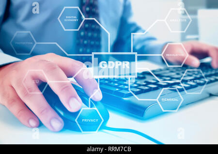 Businessman working with mouse and keyboard on the desk with GDPR protection structure on virtual screen. Cyber security and privacy. General Data Pro Stock Photo