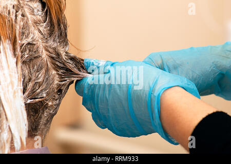 Hairdresser dying a woman's hair Stock Photo