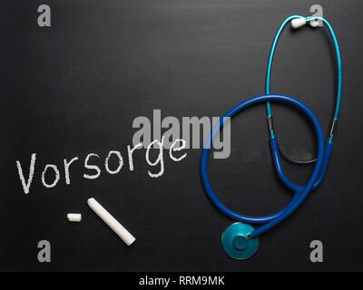 The German word prevention on chalkboard with a stethoscope and space for your text or image Stock Photo