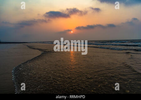 vivid sunrise on a serene calm tranquil deserted beach at digha puri mandarmaniwith space for text Stock Photo