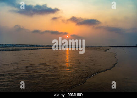 vivid sunrise on a serene calm tranquil deserted beach at digha puri mandarmaniwith space for text Stock Photo