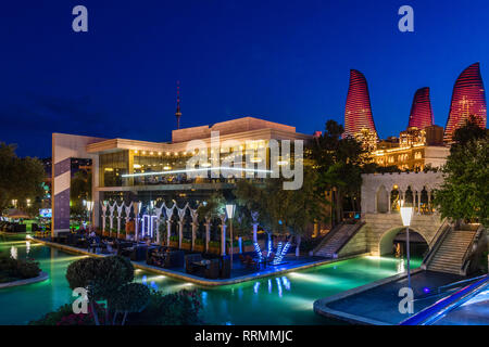 Evening view of central city park with neon highlighted buildings and skyscrapers, Baku, Azerbaijan Stock Photo