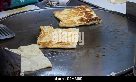 Roti Making, Roti fried on frying pan, Indian traditional street food Stock Photo
