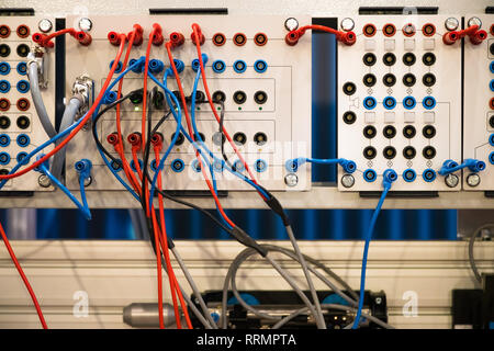 Network cable connecting on network core switch. Machine power controller with cables Stock Photo