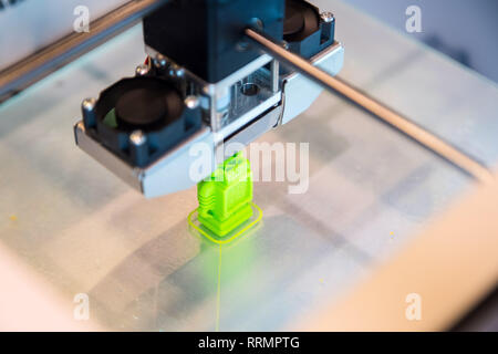 Automatic three dimensional 3d printer performs product creation. Modern 3D printing or additive manufacturing and robotic automation technology Stock Photo