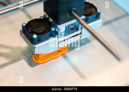 Automatic three dimensional 3d printer performs product creation. Modern 3D printing or additive manufacturing and robotic automation technology Stock Photo