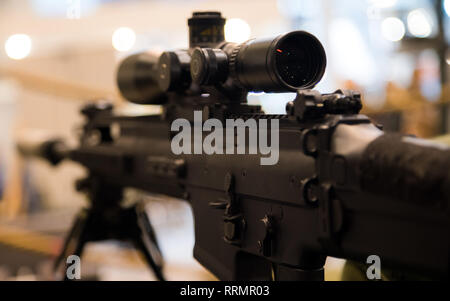 Young soldier aiming machine gun at target during military training in ...