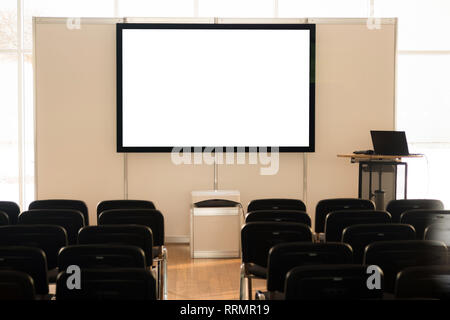 Empty screen in conference room, meeting room, boardroom, Classroom, Office, with white projector board. Stock Photo
