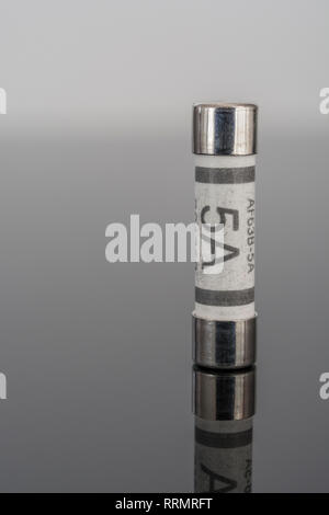 5 Amp household ceramic cartridge fuse. Stock Photo