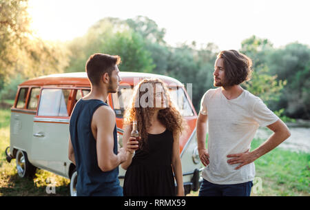 Two boys quarreling over a beautiful young girl on a roadtrip through countryside. Stock Photo