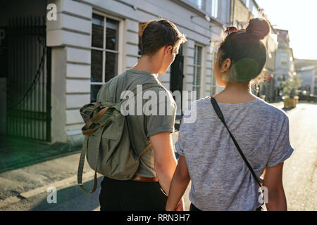 Young couple exploring the city together on foot Stock Photo