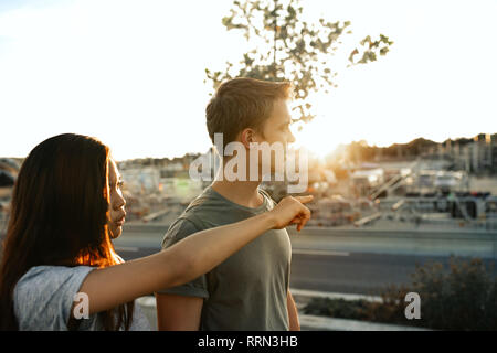 Smiling young couple sightseeing together in the city Stock Photo
