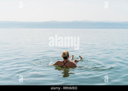 Woman floating, swimming in Dead Sea, Jordan Stock Photo