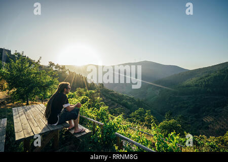 Man enjoying sunny, idyllic landscape view, Chas de Egua, Portugal Stock Photo