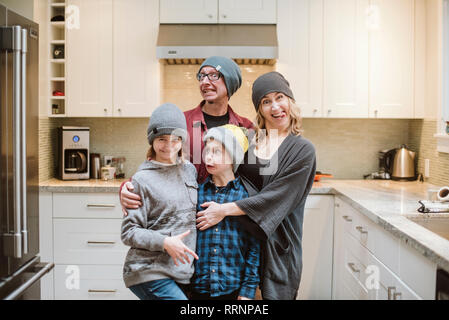 Portrait silly family making faces in kitchen Stock Photo