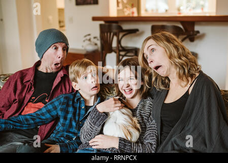 Playful, silly family making faces Stock Photo