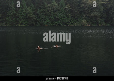 Couple swimming in lake Stock Photo