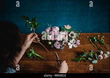 View from above woman arranging flower bouquet Stock Photo