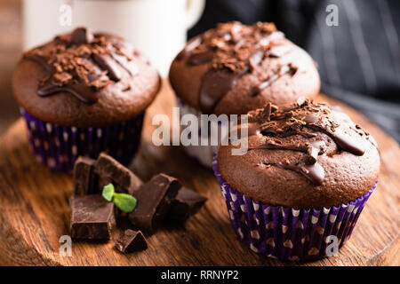 Tasty chocolate muffins decorated with chocolate sauce. Closeup view. Sweet mini cakes Stock Photo