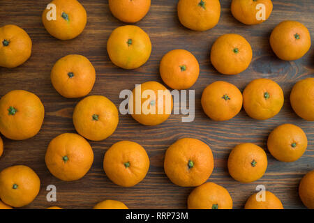 Juicy bright orange tangerines on a wooden background. Fruit set. Background Stock Photo