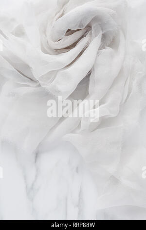White and gray wrinkled silk. Air folds. Silk fabric texture for background or design element. Thin tissue. Stock Photo
