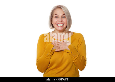 Attractive Middle Aged Woman Smiles emotionally posing in studio on white background Stock Photo