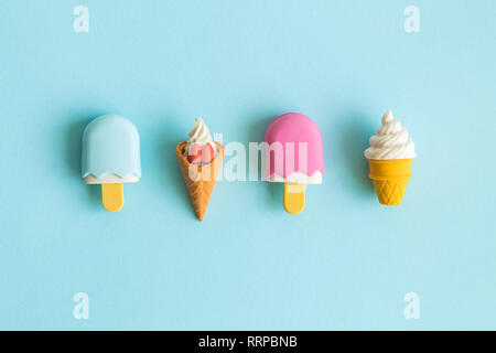 Flat lay of miniature ice cream isolated on pastel blue background minimal creative concept. Stock Photo