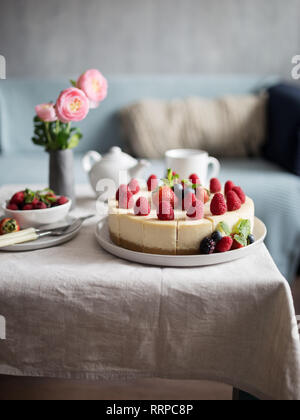 Classic plain New York Cheesecake sliced at plate on table, selective focus, concept of sweet food Stock Photo