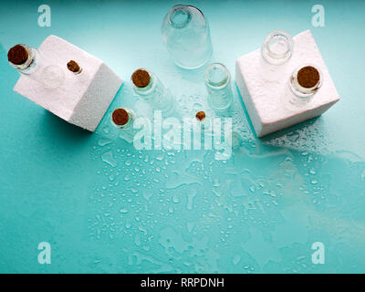 Few transparent bottles, water sprays. empty glass bottles Stock Photo