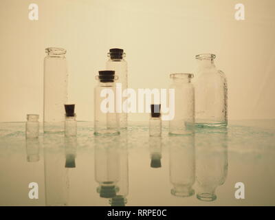 Few transparent bottles, water sprays. empty glass bottles Stock Photo