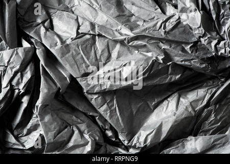 background made of a closeup of a crumpled gray paper Stock Photo