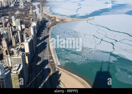 aerial view of Chicago city buildings shadows on Lake Michigan shoreline in winter Stock Photo