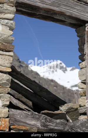 window of abandoned old wood house in italian alps - mountain. Stock Photo