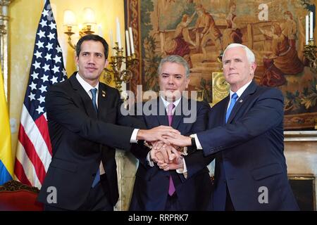 U.S Vice President Mike Pence, right, poses with Juan Guaido, the self-proclaimed interim president of Venezuela, left, and Colombian President Ivan Duque, center, following a meeting of the Lima Group February 25, 2019 in Bogota, Colombia. The U.S. is backing Guaido in an attempt to end the humanitarian crisis in Venezuela. Stock Photo